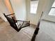 Carpeted staircase with dark wood railing and banister, leading to the upper level of the home at 7815 Shingle Beach St, Las Vegas, NV 89166
