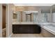 Bathroom featuring double vanity, soaking tub, tile flooring, and ample lighting at 7963 Cape Brett St, Las Vegas, NV 89131