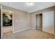 Cozy bedroom featuring neutral carpeting, closet and a doorway to a themed room at 7963 Cape Brett St, Las Vegas, NV 89131