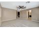 Large bedroom with neutral walls, carpeting, fan and multiple doorways to other rooms at 7963 Cape Brett St, Las Vegas, NV 89131