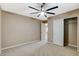 Neutral bedroom featuring plush carpet, ceiling fan, and closet with bi-fold doors at 7963 Cape Brett St, Las Vegas, NV 89131