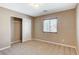Bedroom with neutral carpeting, natural light, and closet with bi-fold doors at 7963 Cape Brett St, Las Vegas, NV 89131