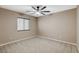 A comfortable bedroom features neutral walls, plush carpeting, and a window for natural light at 7963 Cape Brett St, Las Vegas, NV 89131