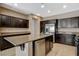 Kitchen with a spacious island, stainless steel appliances, and dark cabinetry offers a functional and stylish space at 7963 Cape Brett St, Las Vegas, NV 89131