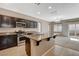 Open kitchen design with island, granite counters, stainless appliances, and easy access to the living space at 7963 Cape Brett St, Las Vegas, NV 89131