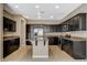 A spacious kitchen features dark wood cabinets, granite countertops, and stainless steel appliances at 7963 Cape Brett St, Las Vegas, NV 89131