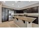 A well-appointed kitchen showcases dark cabinets, stainless appliances, and a granite topped island at 7963 Cape Brett St, Las Vegas, NV 89131
