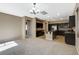 Open-concept design seamlessly connects the living area with carpet to the kitchen with island and dark cabinets at 7963 Cape Brett St, Las Vegas, NV 89131