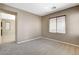 Inviting living room features neutral walls and carpet, complemented by natural light streaming through the window at 7963 Cape Brett St, Las Vegas, NV 89131