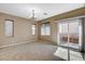 The living room has neutral walls and carpet, with a sliding glass door leading to the outdoors at 7963 Cape Brett St, Las Vegas, NV 89131