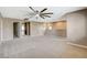 An open loft area with carpet, ceiling fan, and multiple doorways at 7963 Cape Brett St, Las Vegas, NV 89131