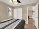 Bedroom features laminate flooring, closet, ceiling fan, and view of upstairs hallway at 8015 Maple Park St, Las Vegas, NV 89131