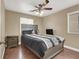 Bedroom with laminate flooring, window, ceiling fan, and a gray color scheme at 8015 Maple Park St, Las Vegas, NV 89131