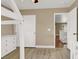 Bedroom featuring laminate floors, ceiling fan, closet, and access to the hallway at 8015 Maple Park St, Las Vegas, NV 89131