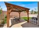 This outdoor gazebo features a corrugated metal roof, timber framing, and space for a table and chairs at 8015 Maple Park St, Las Vegas, NV 89131