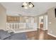 Sitting area hallway with laminate flooring, neutral walls, and white banister at 8015 Maple Park St, Las Vegas, NV 89131