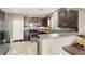 Well-equipped kitchen with stainless steel appliances, dark wood cabinets, and tile backsplash at 8015 Maple Park St, Las Vegas, NV 89131