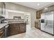 Spacious kitchen with stainless steel appliances, dark cabinetry, and an open view to the living area at 8015 Maple Park St, Las Vegas, NV 89131