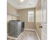 Laundry room featuring front-loading washer and dryer, as well as a utility sink at 8015 Maple Park St, Las Vegas, NV 89131