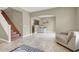 Bright living room with tile flooring, comfortable seating, and an open layout to the dining area and stairs at 8015 Maple Park St, Las Vegas, NV 89131