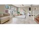 Cozy living room with large windows, tile flooring, a ceiling fan, and comfortable seating at 8015 Maple Park St, Las Vegas, NV 89131