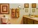 Traditional bathroom features a toilet, towel rack, and vanity with framed art pieces at 8777 Maule Ave # 3116, Las Vegas, NV 89148
