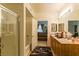 Bathroom featuring double sinks with a large mirror, walk-in shower and open doorway to the bedroom at 8777 Maule Ave # 3116, Las Vegas, NV 89148