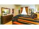 Comfortable bedroom featuring wooden furniture, stylish decor, and an open doorway to the hallway at 8777 Maule Ave # 3116, Las Vegas, NV 89148