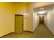 Condo hallway features well-lit entrance with carpet and a welcome mat at the door at 8777 Maule Ave # 3116, Las Vegas, NV 89148