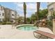 Relaxing hot tub area with rock waterfall feature and lounge chairs at 8777 Maule Ave # 3116, Las Vegas, NV 89148