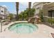 Inviting hot tub with rock waterfall feature near seating and landscaping at 8777 Maule Ave # 3116, Las Vegas, NV 89148