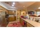 An open kitchen boasts stainless steel appliances, wooden cabinets, and countertop seating at 8777 Maule Ave # 3116, Las Vegas, NV 89148