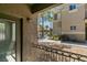 A balcony view overlooking the community pool and well-maintained landscaping with mature palm trees at 9050 W Warm Springs Rd # 1117, Las Vegas, NV 89148