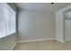 This is a bright bedroom with neutral colors and a large window with window blinds at 9050 W Warm Springs Rd # 1117, Las Vegas, NV 89148
