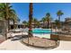 Relaxing community pool surrounded by palm trees, lounge chairs, and a patio area at 9050 W Warm Springs Rd # 1117, Las Vegas, NV 89148