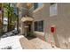 Exterior view of the building showing the front door with covered porch and manicured landscaping at 9050 W Warm Springs Rd # 1117, Las Vegas, NV 89148
