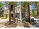Well-maintained exterior with mature trees, landscaping, and pedestrian walkway leading to the building entrance at 9050 W Warm Springs Rd # 1117, Las Vegas, NV 89148