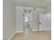 Neutral hallway leading to the bathroom, closet and an additional bedroom at 9050 W Warm Springs Rd # 1117, Las Vegas, NV 89148