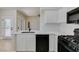 Modern kitchen featuring white cabinets, countertops, and black appliances at 9050 W Warm Springs Rd # 1117, Las Vegas, NV 89148