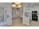 View of the kitchen with white cabinets, tile floors, and stainless steel appliances at 9050 W Warm Springs Rd # 1117, Las Vegas, NV 89148
