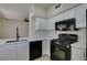 Bright kitchen with sleek countertops, white cabinetry, and modern black appliances at 9050 W Warm Springs Rd # 1117, Las Vegas, NV 89148