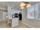Updated kitchen showcasing quartz countertop, black appliances, and a chandelier over breakfast nook at 9050 W Warm Springs Rd # 1117, Las Vegas, NV 89148
