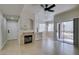 Living room features a fireplace, open layout, tile flooring, and access to patio at 9050 W Warm Springs Rd # 1117, Las Vegas, NV 89148