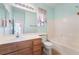 Bathroom features a single sink vanity, tiled floors and a tub with white subway tile at 940 Rifle Dr, Henderson, NV 89002