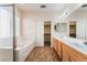 Well-lit bathroom features a separate shower, soaking tub, double sinks, and a walk-in closet at 940 Rifle Dr, Henderson, NV 89002