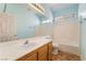 Well-lit bathroom with a single sink vanity, shower-tub combo, and tiled flooring at 940 Rifle Dr, Henderson, NV 89002