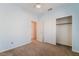 Cozy bedroom with carpet, ceiling fan, closet, and views to the hallway at 940 Rifle Dr, Henderson, NV 89002