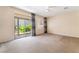 Carpeted bedroom featuring a sliding glass door to the backyard and natural light at 940 Rifle Dr, Henderson, NV 89002