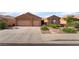 Charming single-story home with a three-car garage, desert landscaping, and neutral color palette at 940 Rifle Dr, Henderson, NV 89002