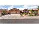 Charming single-story home with a three-car garage, desert landscaping, and neutral color palette at 940 Rifle Dr, Henderson, NV 89002